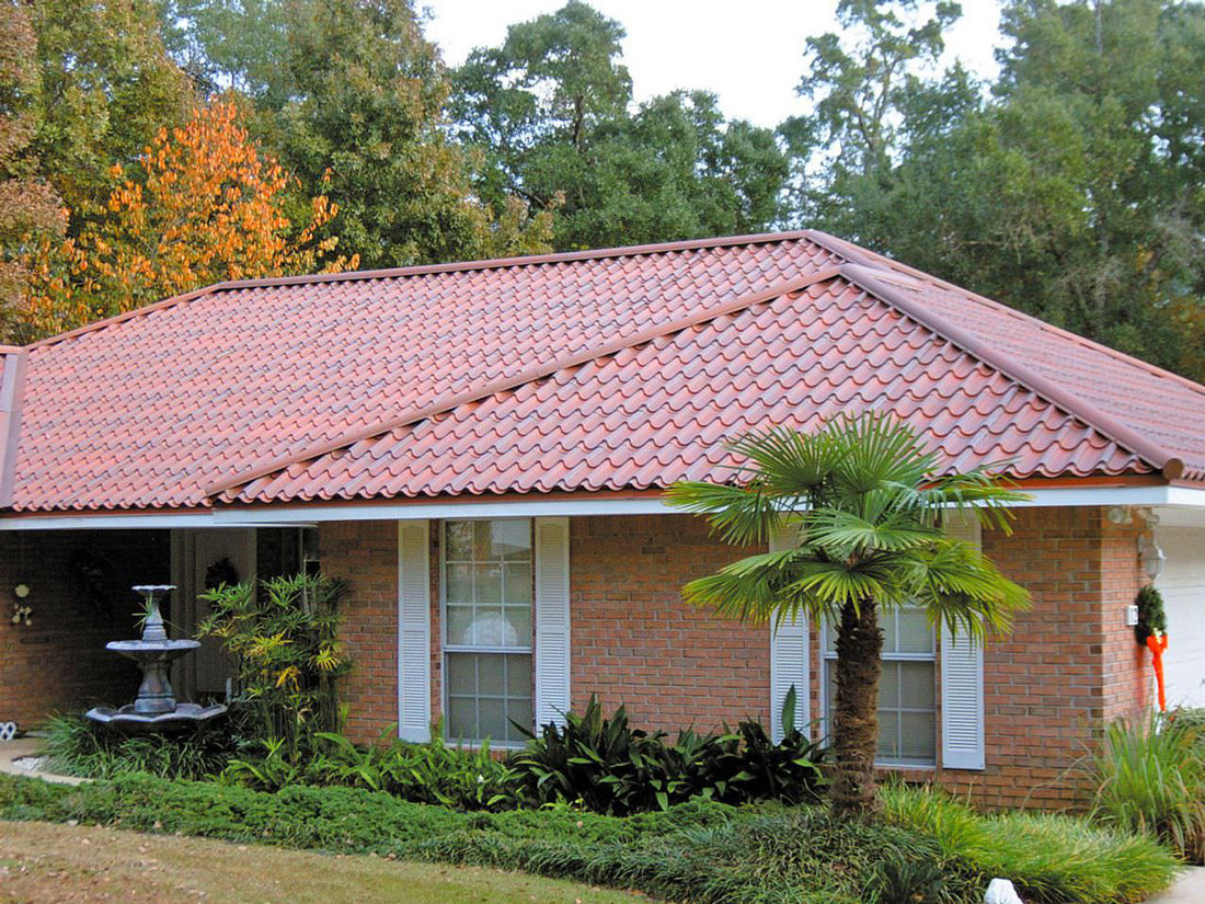 Rows of rounded aluminum barrel tiles on a Grandetile metal roof