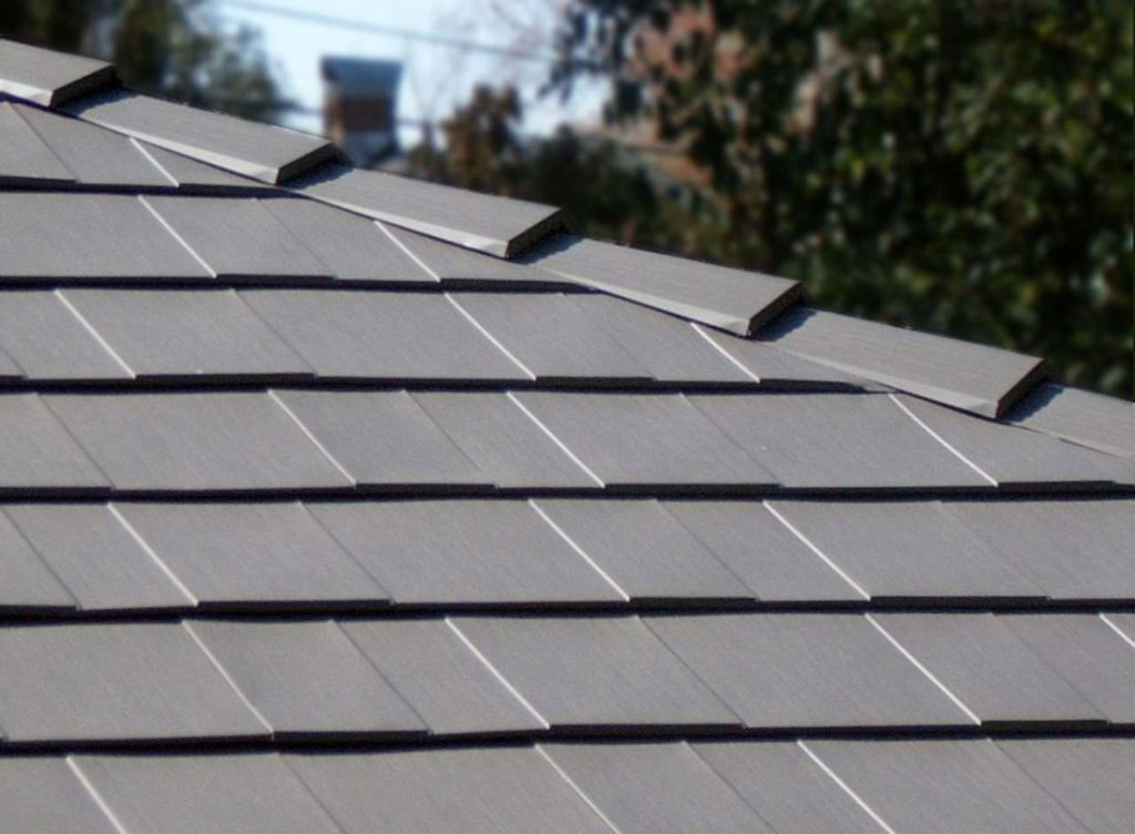 HOA Metal Roof Approval in Texas: What the Law Says and What to Submit Close-up of gray Oxford metal shingles with interlocking edges on a sloped roof