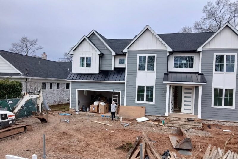 Black Standing Seam Garage and Porch Roofs on a Gray Home