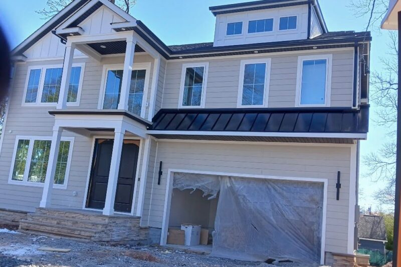 Long Standing Seam Roof Over the Garage of a Beige Home