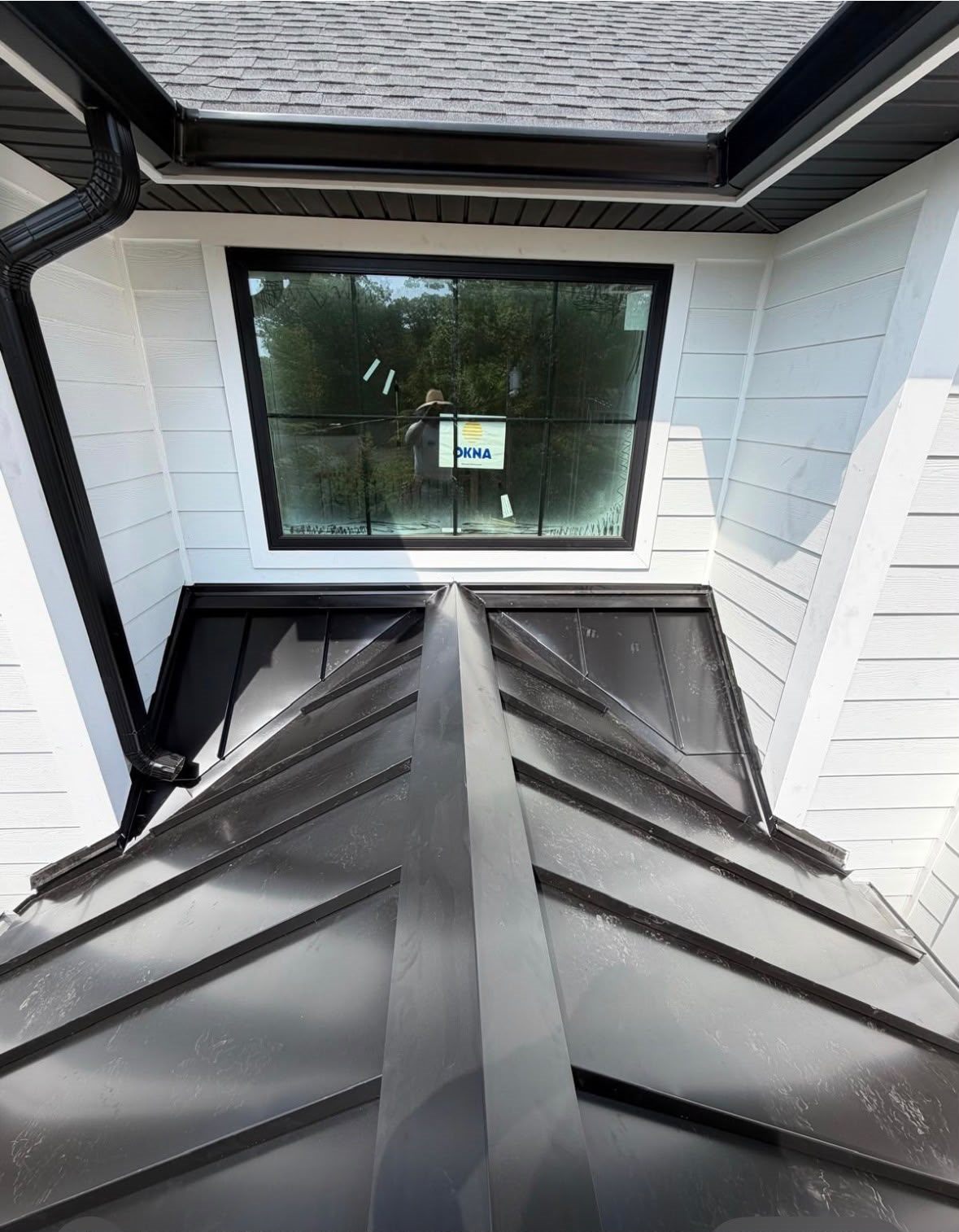 Services Top view of a standing seam bay roof with a hip cap