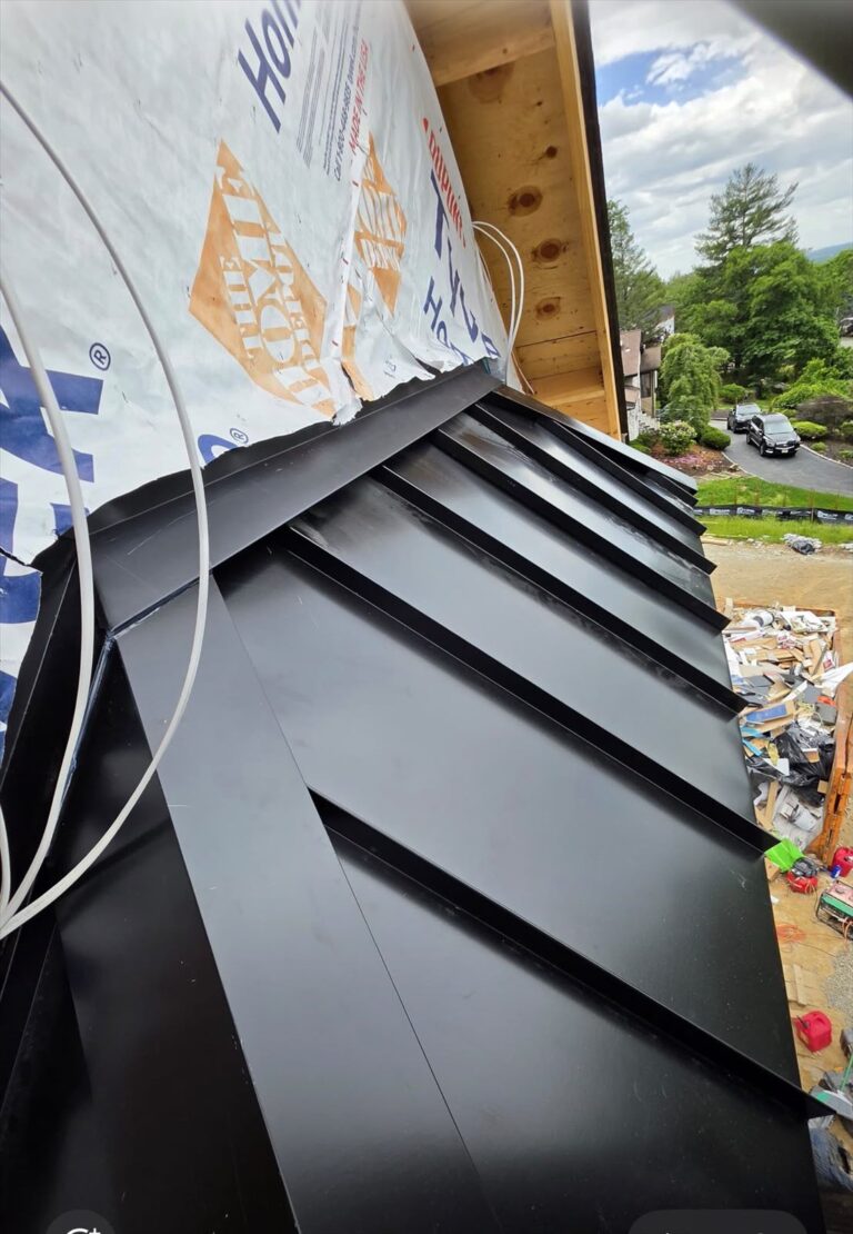 Home Standing seam hip roof partway through installation