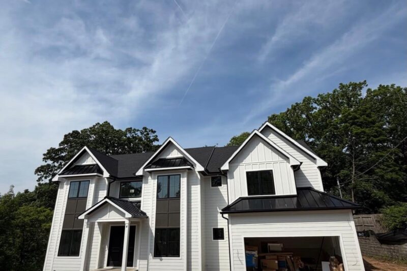 Black Standing Seam Accent Roofs on a Large White Home
